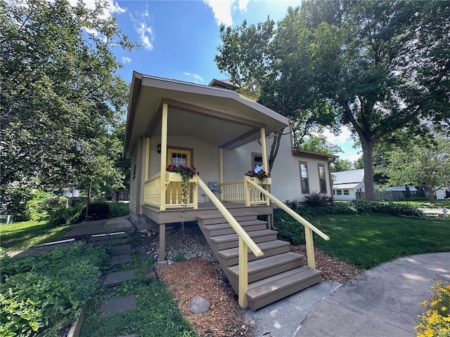 view of front of home with covered porch and a front yard