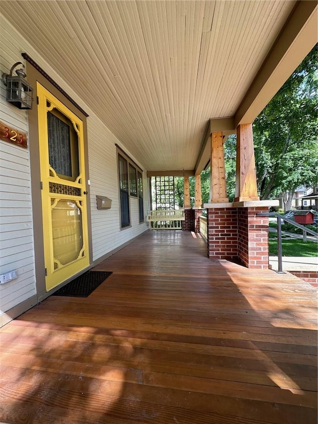 wooden terrace with a porch