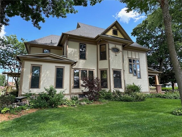 victorian home with a front lawn