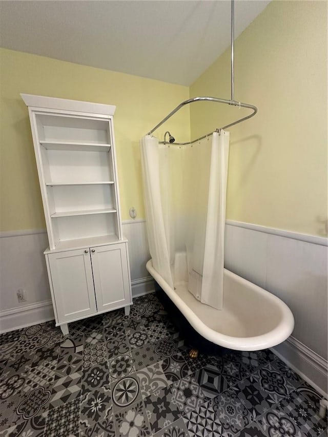 bathroom featuring tile patterned flooring and shower / bath combo with shower curtain