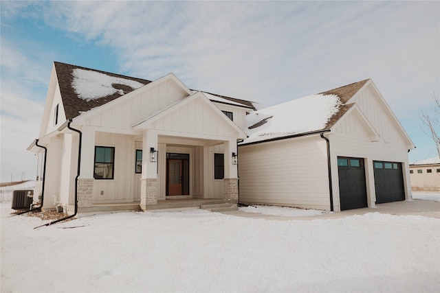 modern farmhouse with cooling unit and a garage