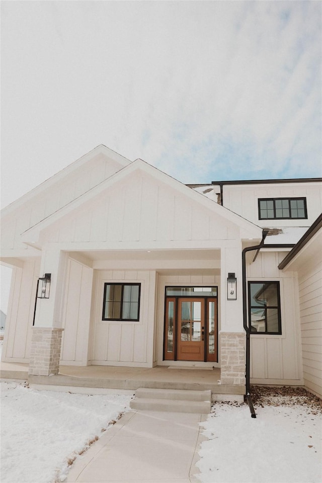 view of snow covered property entrance