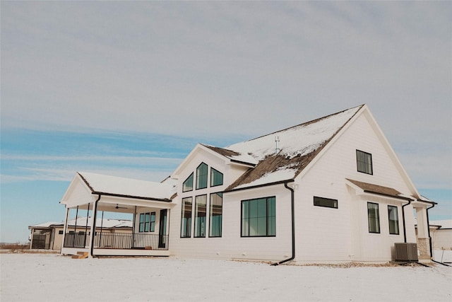 snow covered house with cooling unit