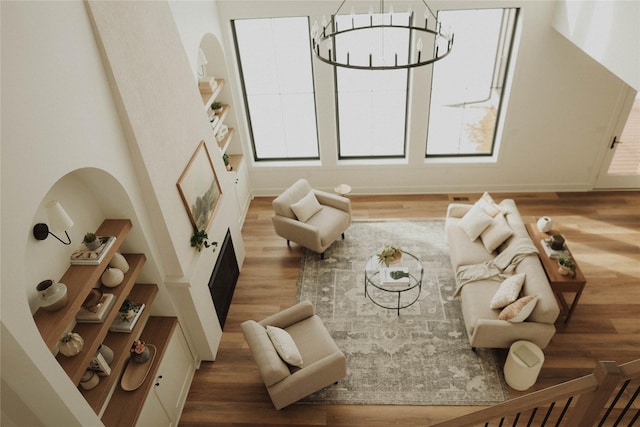 living area with hardwood / wood-style flooring and an inviting chandelier