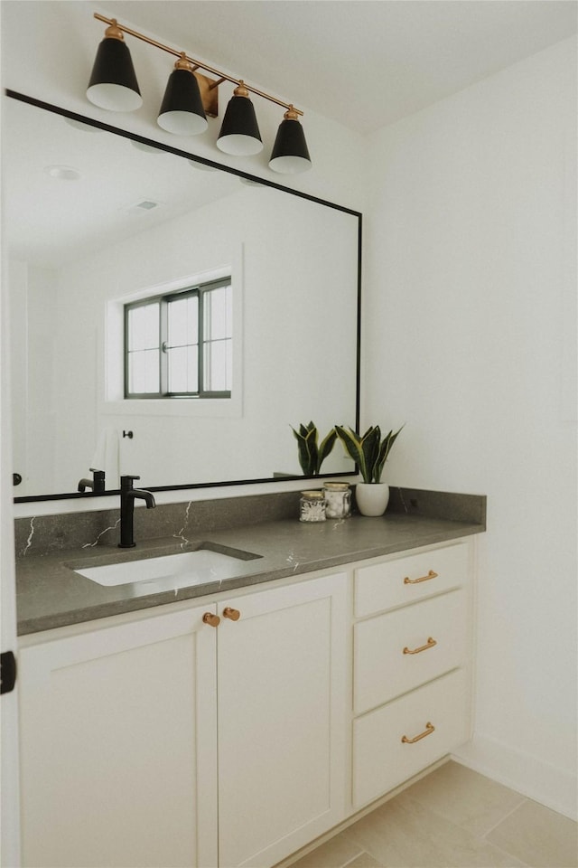 bathroom with tile patterned flooring and vanity