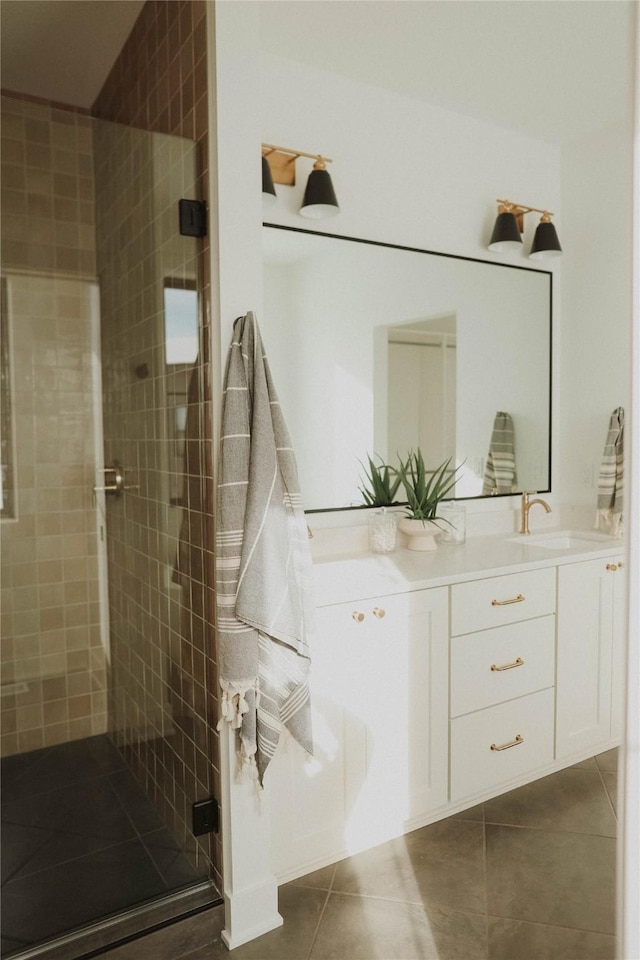 bathroom with tile patterned flooring, vanity, and a shower with door