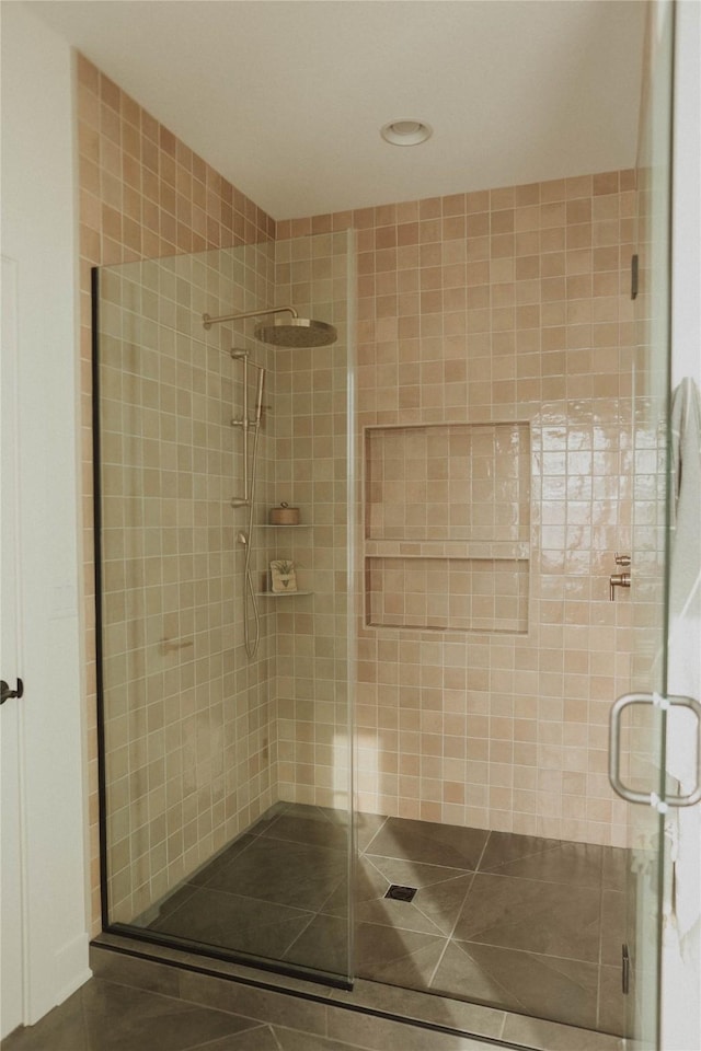 bathroom featuring tile patterned floors and an enclosed shower