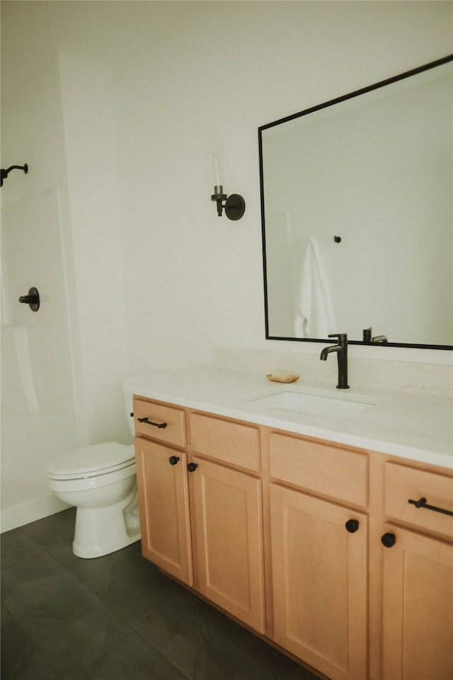 bathroom featuring tile patterned floors, vanity, and toilet