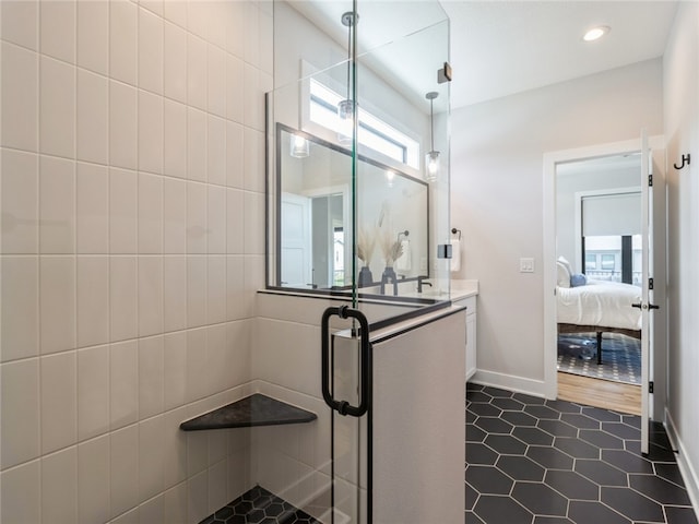 bathroom featuring walk in shower, tile patterned flooring, and vanity