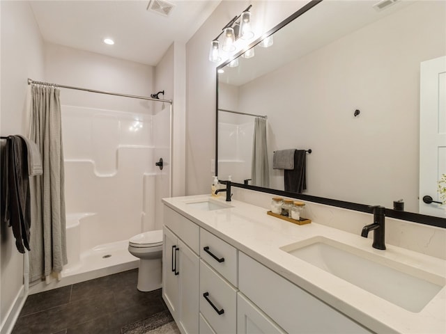 bathroom featuring toilet, vanity, a shower with shower curtain, and tile patterned floors