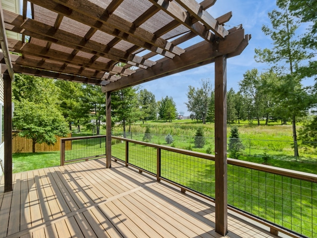 deck featuring a pergola and a lawn