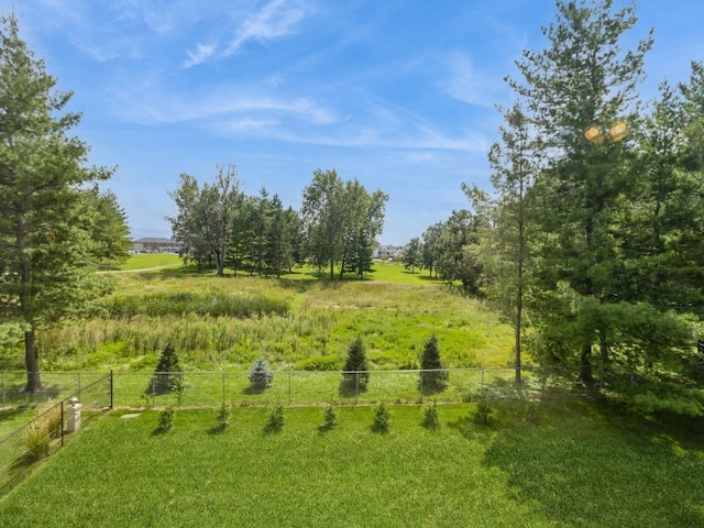 view of yard featuring fence and a rural view