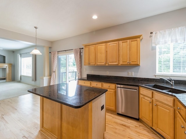 kitchen with a sink, open floor plan, stainless steel dishwasher, a center island, and decorative light fixtures