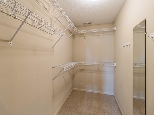 walk in closet with visible vents