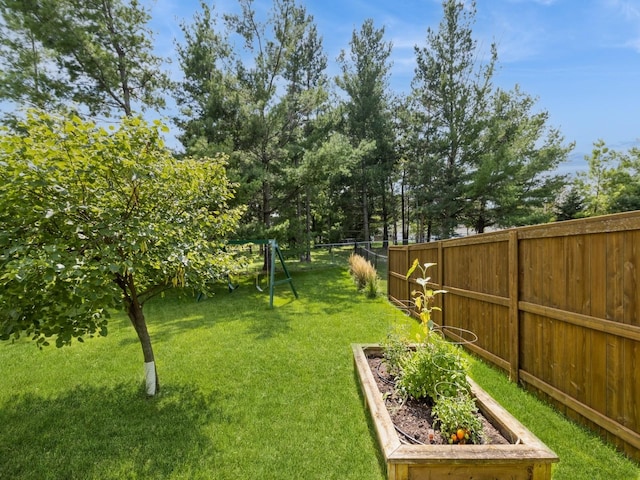 view of yard with a garden and fence