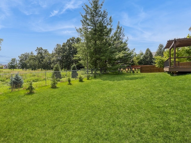 view of yard with a fenced backyard, a deck, and a pergola