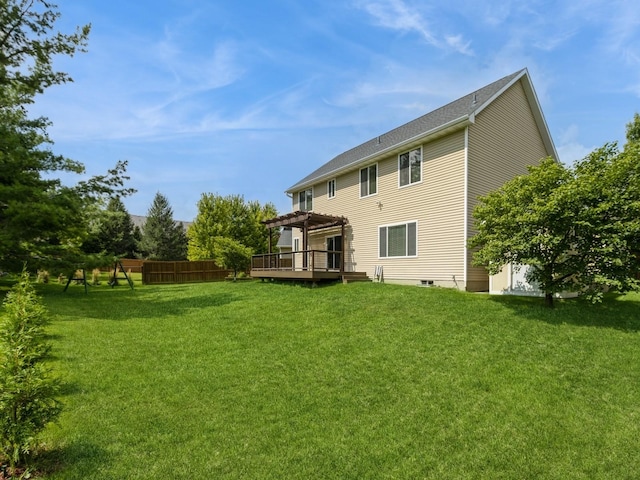 rear view of property featuring fence, a lawn, a deck, and a pergola