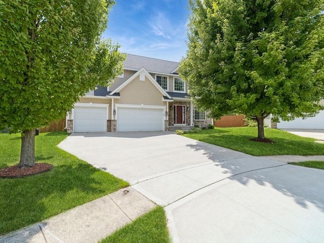 view of front facade with stone siding, driveway, and a front lawn