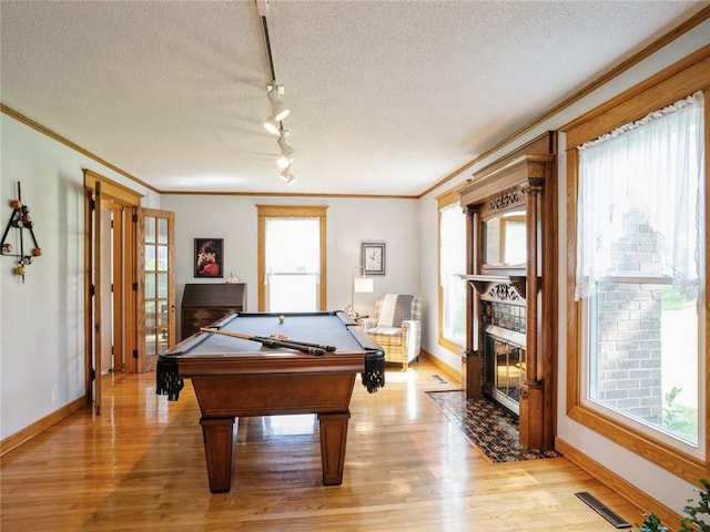 game room with a wealth of natural light, pool table, and ornamental molding