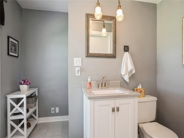 bathroom featuring toilet, tile patterned flooring, and vanity