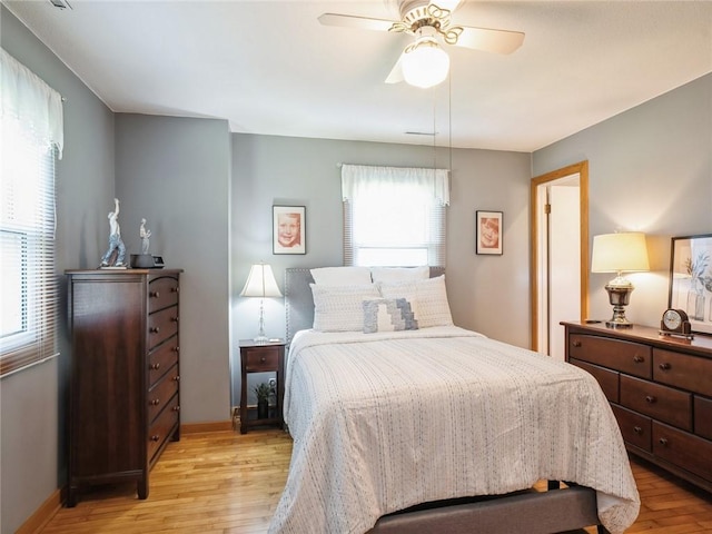 bedroom with ceiling fan and light hardwood / wood-style flooring