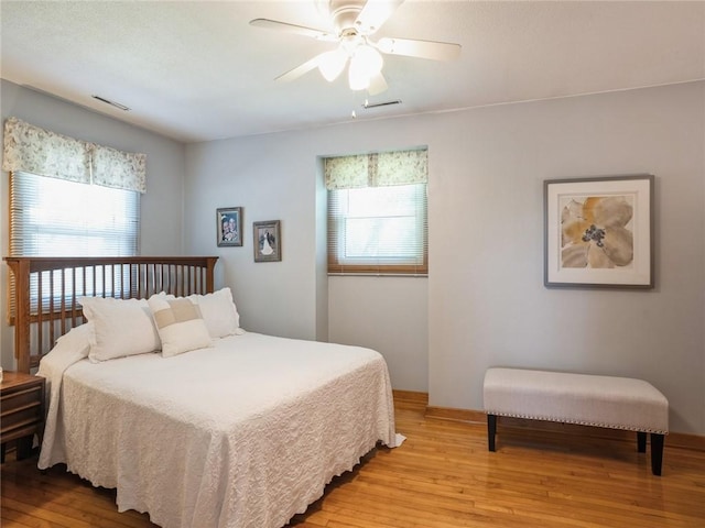 bedroom with ceiling fan and light hardwood / wood-style flooring