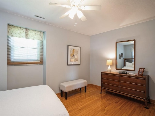 bedroom with ceiling fan and light hardwood / wood-style floors