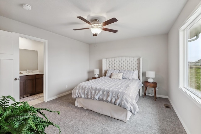2925 3rd Ave SW, Altoona, IA 50009 - bedroom with light carpet, baseboards, ensuite bath, and ceiling fan