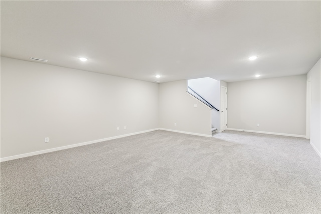 basement featuring light colored carpet