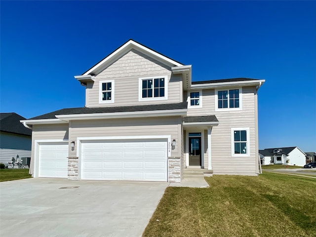 view of front of property with a front lawn and a garage