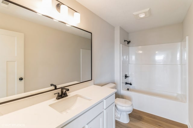 full bathroom featuring vanity, toilet, bathtub / shower combination, and hardwood / wood-style floors