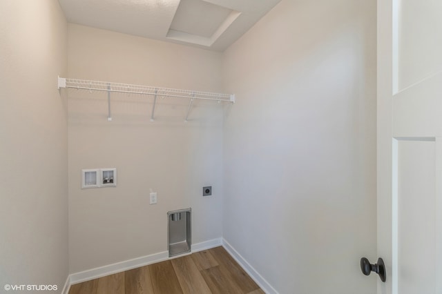 washroom with hookup for a washing machine, hardwood / wood-style floors, and electric dryer hookup