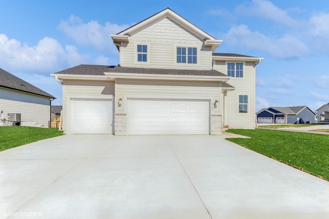 view of front of house with a front yard, a garage, and central AC unit