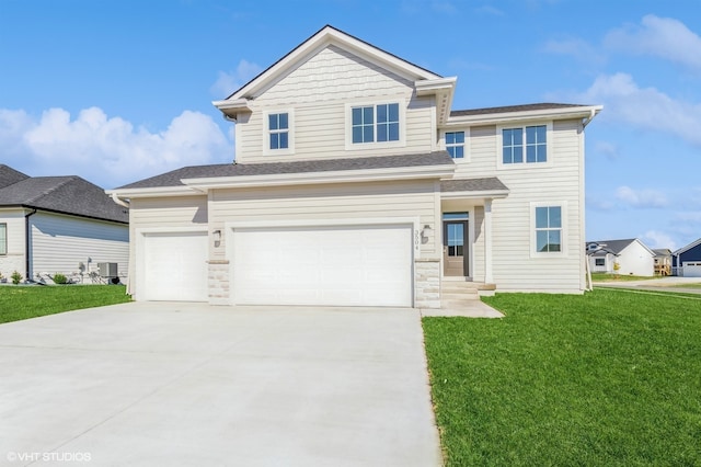 view of front of property featuring a front yard, driveway, and an attached garage