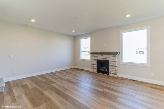 unfurnished living room with light hardwood / wood-style flooring and a fireplace