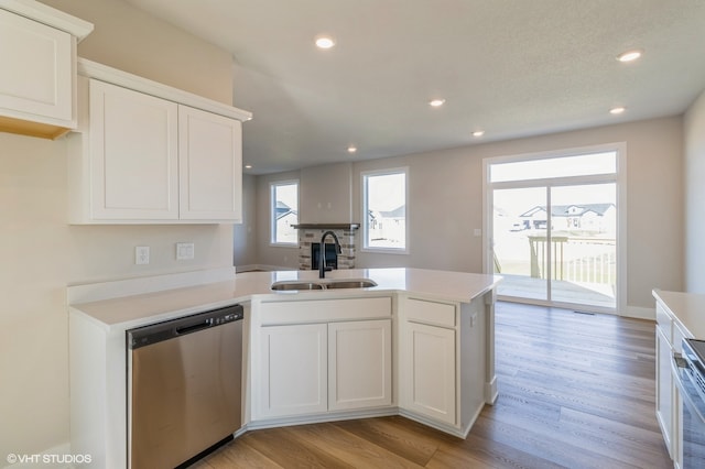 kitchen featuring white cabinetry, light hardwood / wood-style flooring, sink, and stainless steel dishwasher