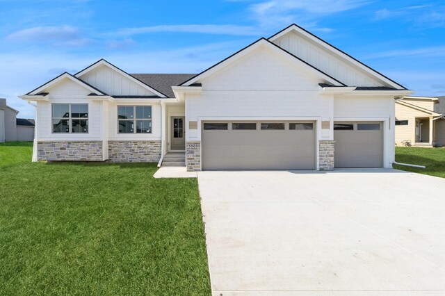 3505 NW 28th St, Ankeny, IA 50023 - view of front of house with board and batten siding, driveway, stone siding, and a garage