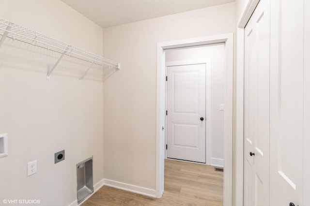 washroom with laundry area, light wood-type flooring, electric dryer hookup, and baseboards