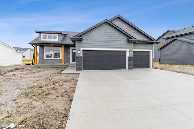 view of front of property featuring a garage and concrete driveway