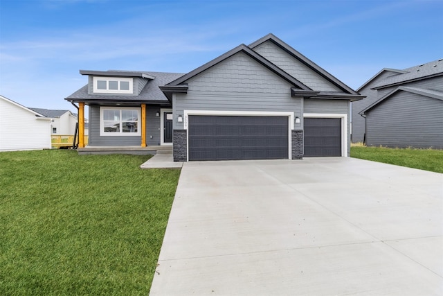 view of front of house with a garage, a front yard, and driveway