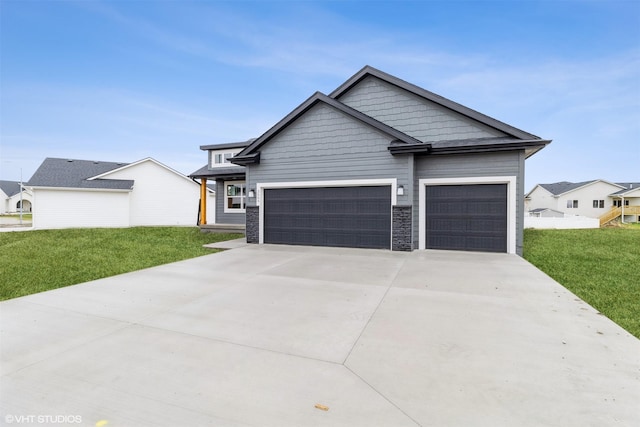 view of front facade featuring a front yard, concrete driveway, and an attached garage