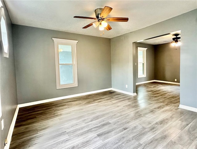 unfurnished room featuring ceiling fan, a textured ceiling, and light hardwood / wood-style flooring