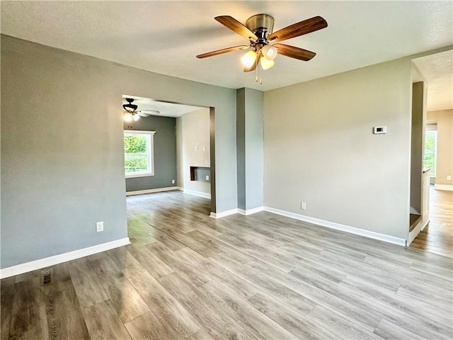 spare room featuring ceiling fan and light wood-type flooring