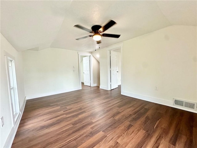 unfurnished room with ceiling fan, lofted ceiling, and dark hardwood / wood-style floors