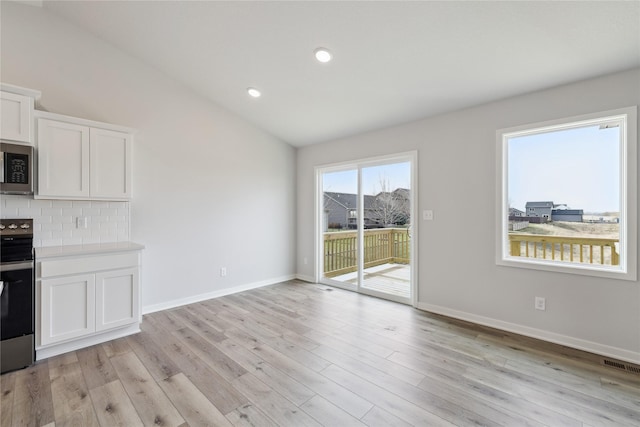 interior space featuring light hardwood / wood-style flooring and vaulted ceiling