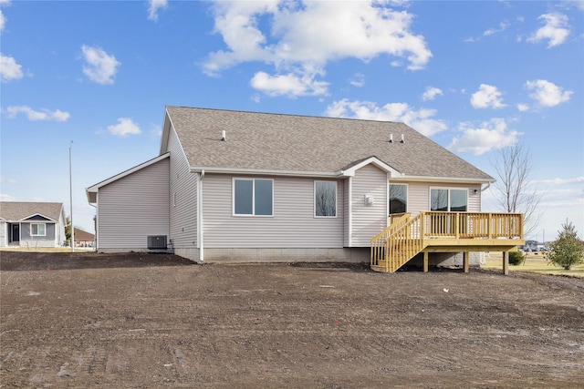 rear view of house with central air condition unit and a wooden deck