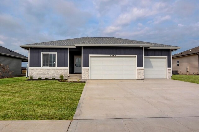 prairie-style home featuring a garage and a front yard