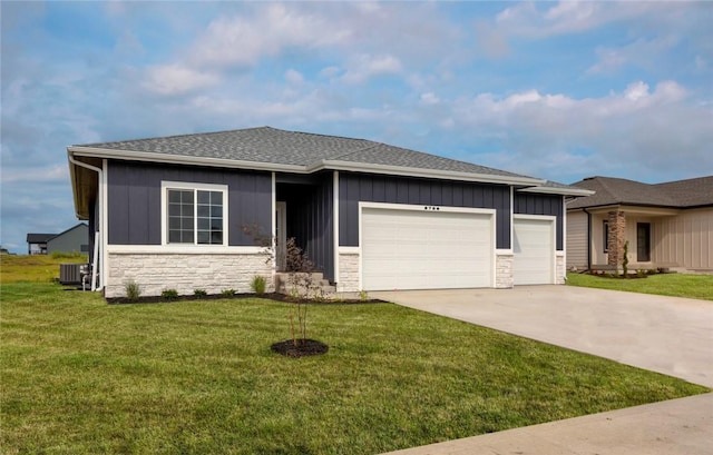 prairie-style home with a garage, a front yard, and central air condition unit