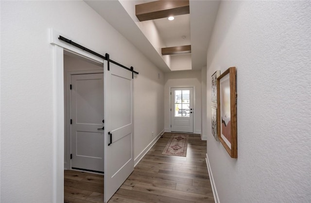 hall featuring hardwood / wood-style flooring and a barn door