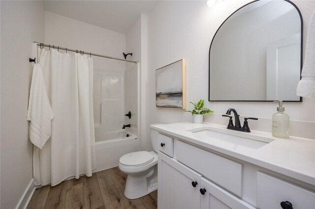 full bathroom featuring vanity, hardwood / wood-style flooring, toilet, and shower / bath combination with curtain